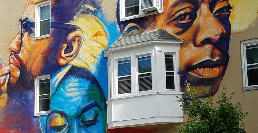 A mural on the side of a row house in the city of Baltimore.